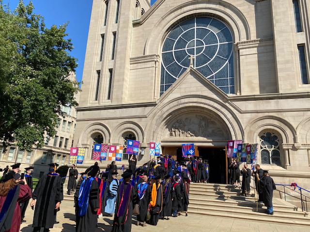 DePaul faculty and staff proceed into St. Vincent de Paul Parish Church